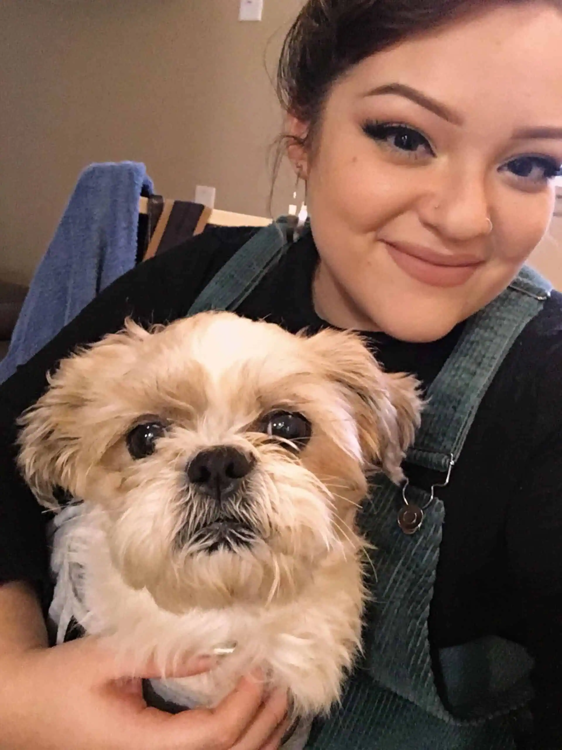 woman with a small tan dog