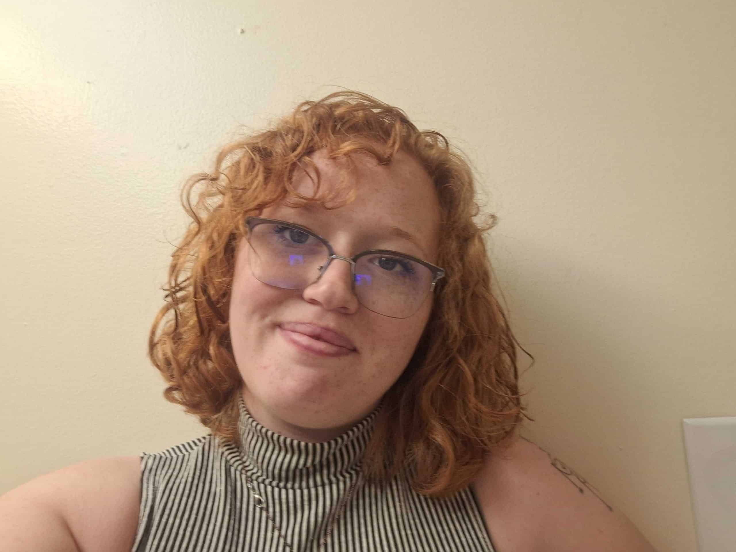 woman standing in front of a white wall