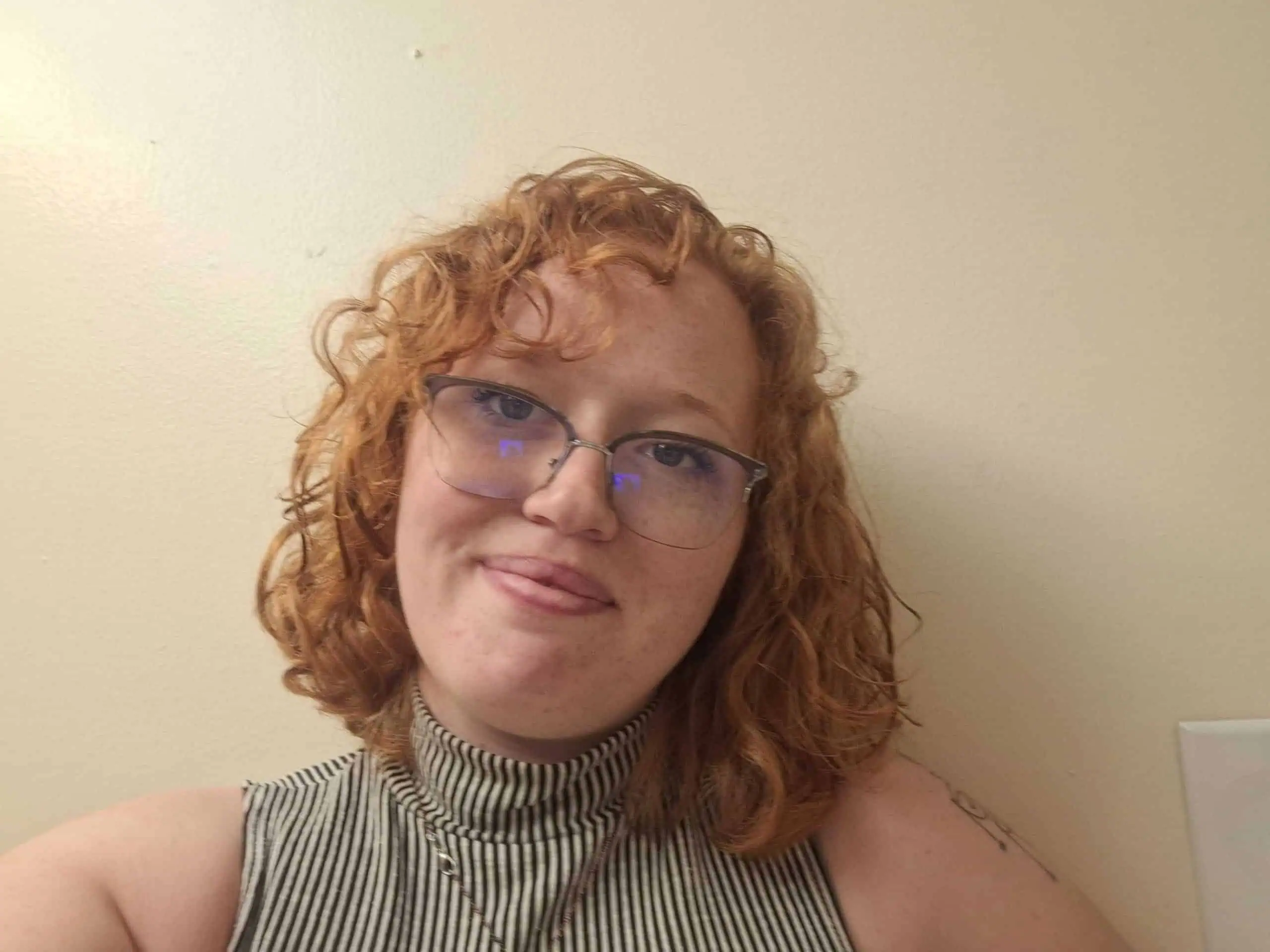 woman standing in front of a white wall