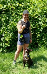 man and black puppy doing dog behavior training