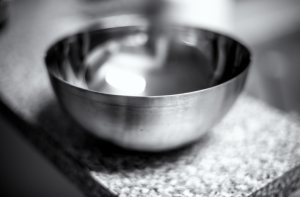 black and white stock photo of an empty metal bowl on counter used for dog enrichment
