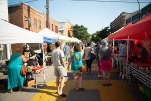 people walking through a farmers market near Ann Arbor